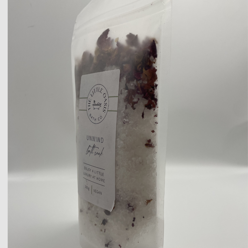 Bath soak with visible flower petals and a label on a white background
