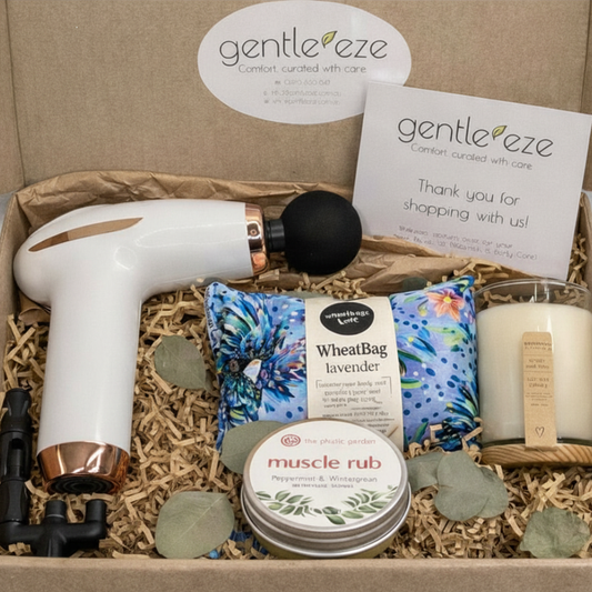 Gentle Eze gift set with massage gun, wheat bag, muscle rub, and candle in a box.

